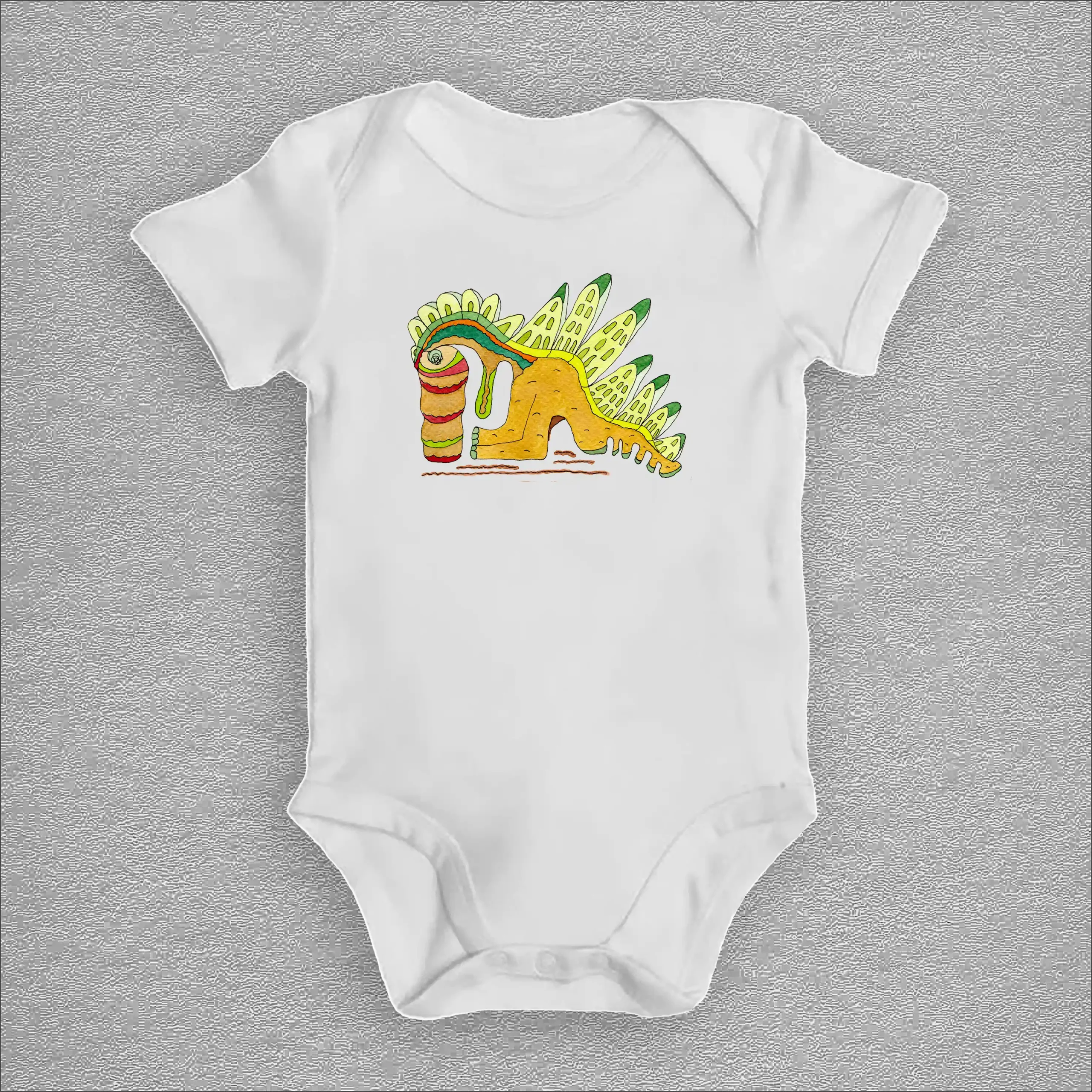 White baby bodysuit featuring a colorful hand-drawn dinosaur illustration with green back plates and a whimsical prehistoric fantasy design.